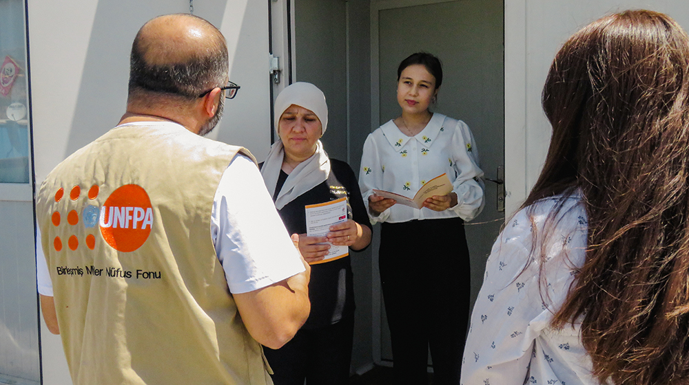 UNFPA visits containers on the ground with its partners to provide people with information about adolescent health and development. 