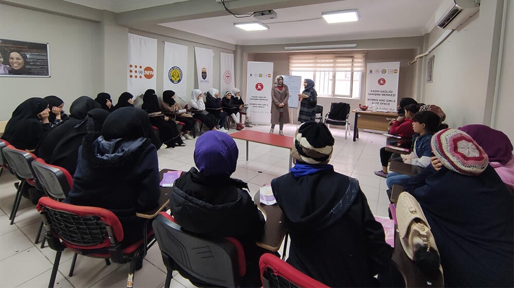 midwife is organizing an awareness raising event with girls about menstrual cycle